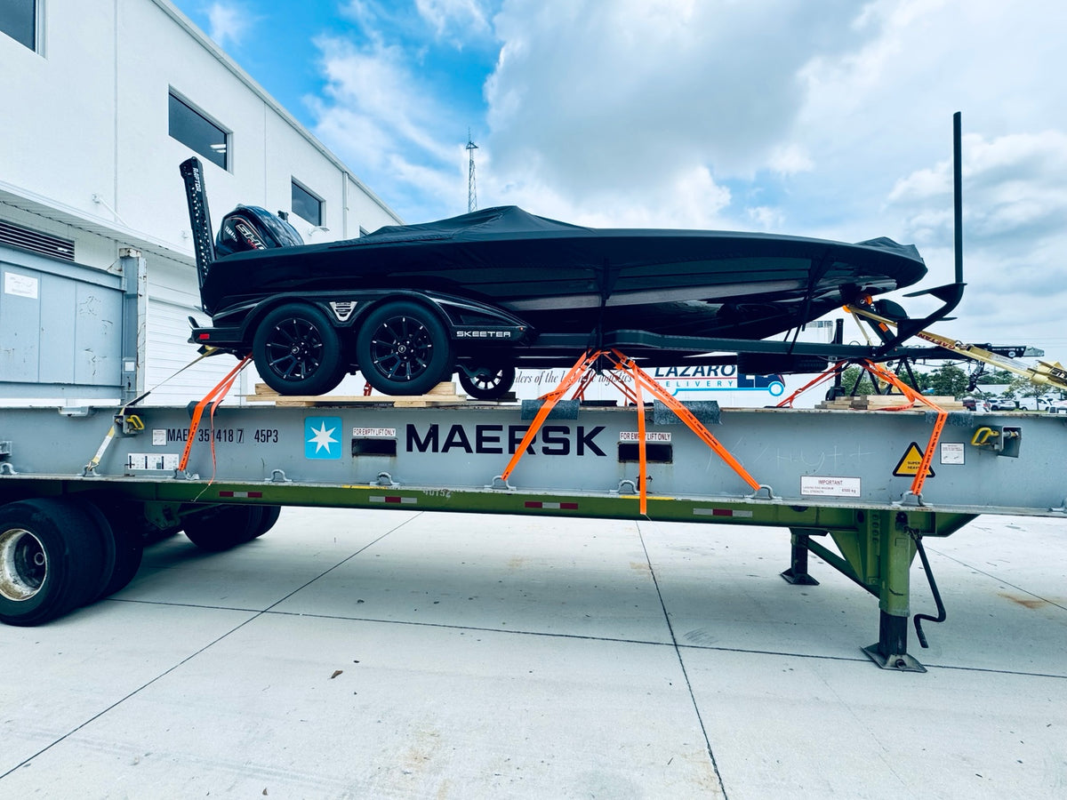 Boat and trailer secured on a shipping platform for international transport